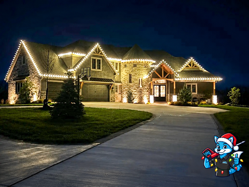 Large stone home with illuminated Christmas rooflines